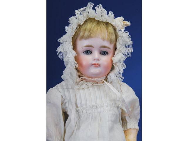 Appraisal: Closed Mouth Kestner Child with Wardrobe Germany ca bisque socket