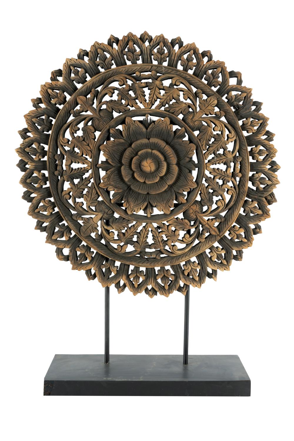 Appraisal: INDONESIAN CARVED WOOD DISCmounted on a painted wood plinth Provenance