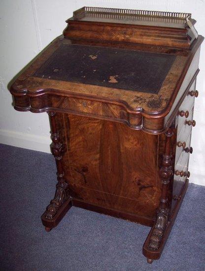 Appraisal: An Edwardian walnut and inlaid Davenport the top with galleried