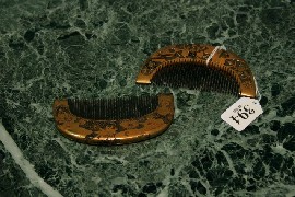 Appraisal: A pair of Japanese crescent-shaped combs decorated in gilt and