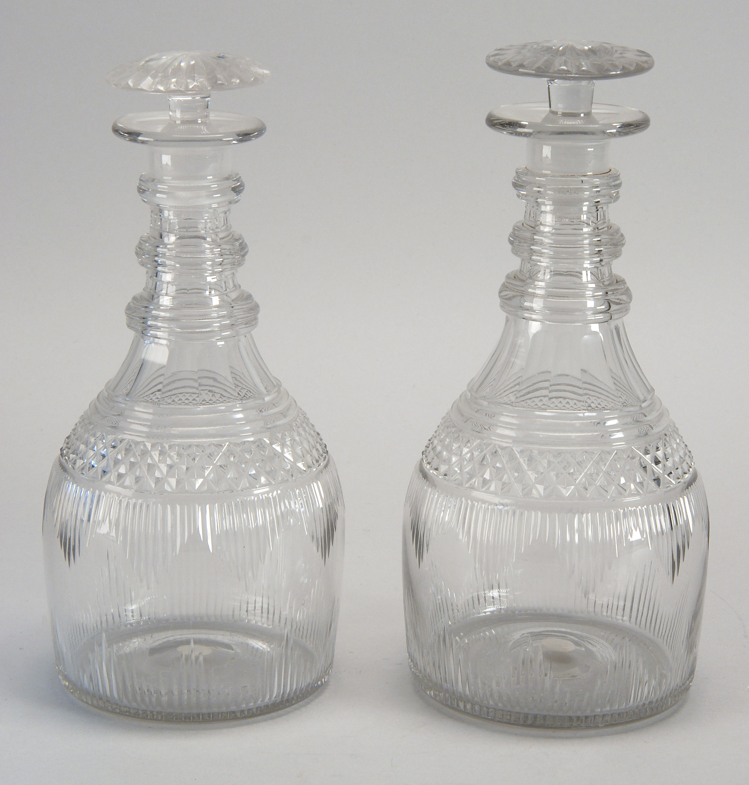 Appraisal: PAIR OF CLEAR BLOWN CUT GLASS DECANTERS Probably Irish th