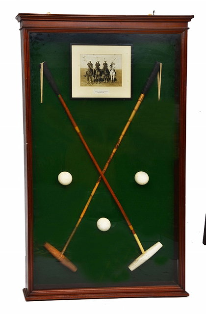 Appraisal: A PAIR OF CROSSED POLO STICKS together with three balls