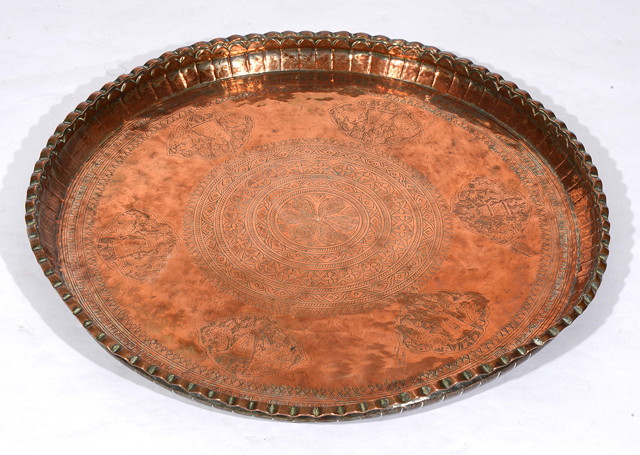 Appraisal: A LARGE ISLAMIC BEATEN COPPER TRAY with engraved decoration diameter