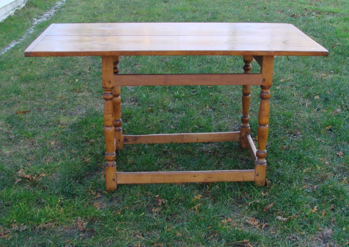 Appraisal: ANTIQUE AMERICAN TAVERN TABLE In pine and maple with breadboard