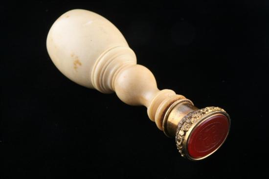 Appraisal: CONTINENTAL CARVED IVORY AND INTAGLIO-CUT CARNELIAN MONOGRAMMED SEAL Oval seal