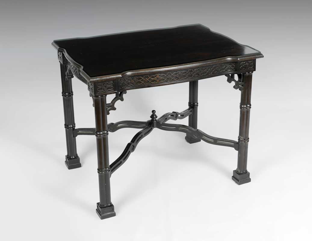 Appraisal: EBONIZED CARVED FAUX BAMBOO OCCASIONAL TABLE Shaped top with fitted