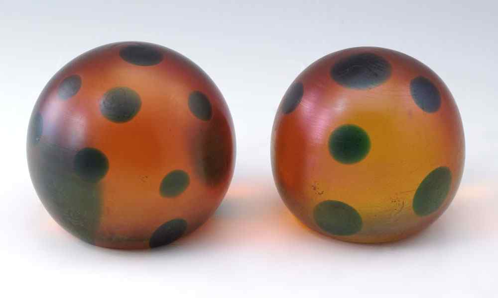 Appraisal: PAIR OF TIFFANY PAPERWEIGHTS Amber color base with green coin