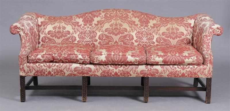 Appraisal: GEORGE III STYLE CARVED MAHOGANY SERPENTINE-BACK SOFA With down-swept roll-over