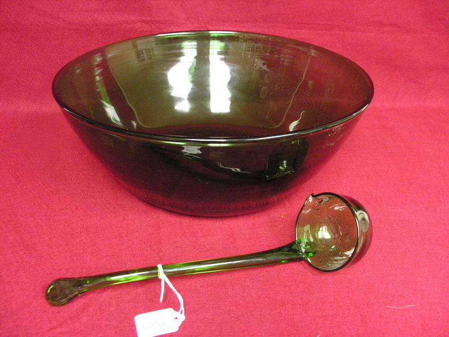 Appraisal: LARGE GREEN ART GLASS PUNCHBOWL AND LADLE Ground pontil on