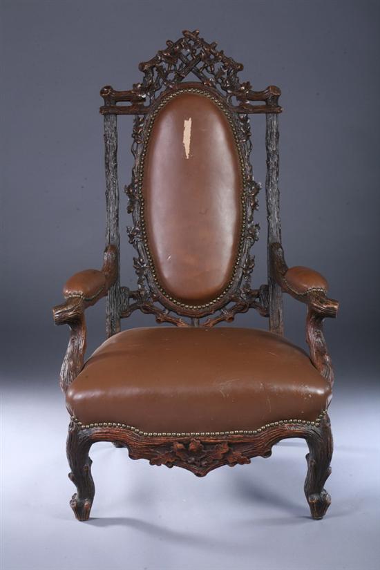 Appraisal: BLACK FOREST CARVED WALNUT ARMCHAIR late th century with nailed