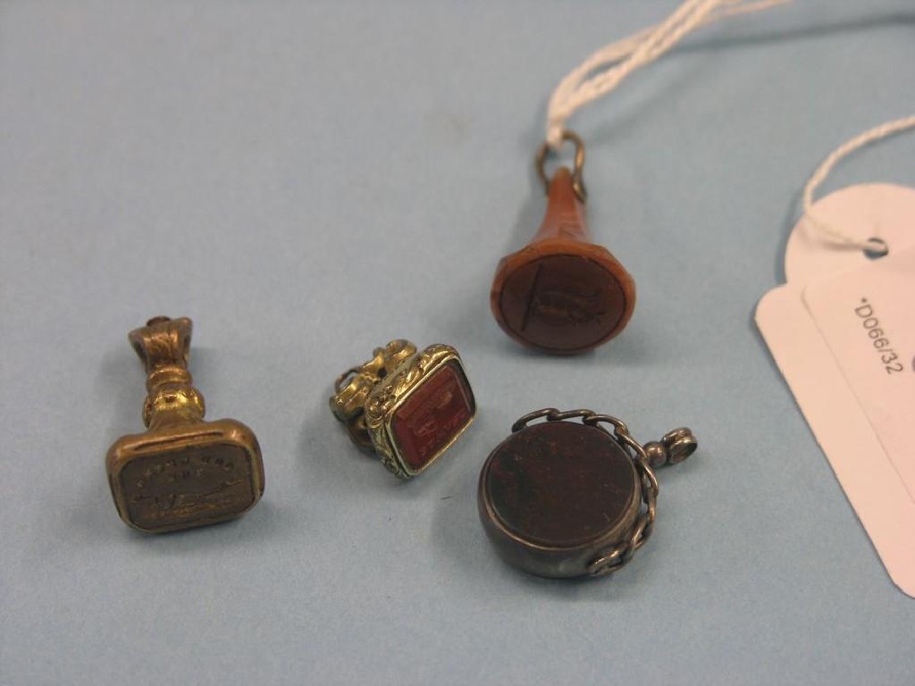 Appraisal: A silver mounted gemstone pendant and three pendant seals