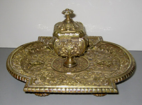 Appraisal: CONTINENTAL CAST METAL ENCRIER To a shaped tray mounted single