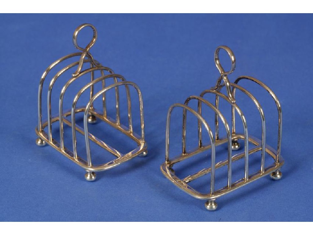 Appraisal: A PAIR OF SILVER TOAST RACKS each with five bars