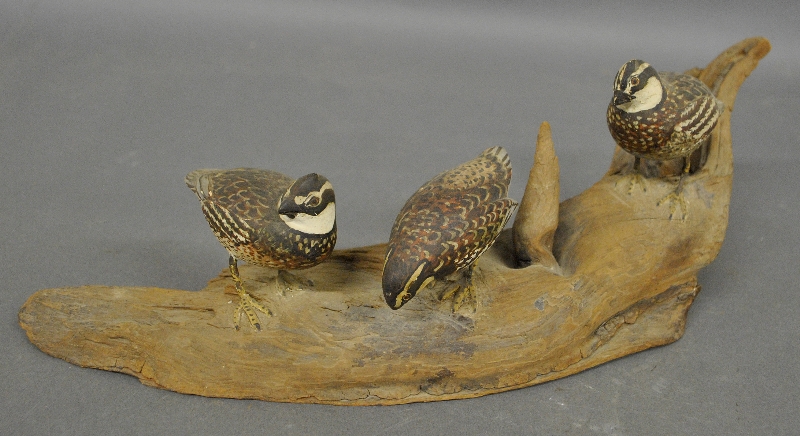 Appraisal: - Three carved quails on a driftwood base probably by