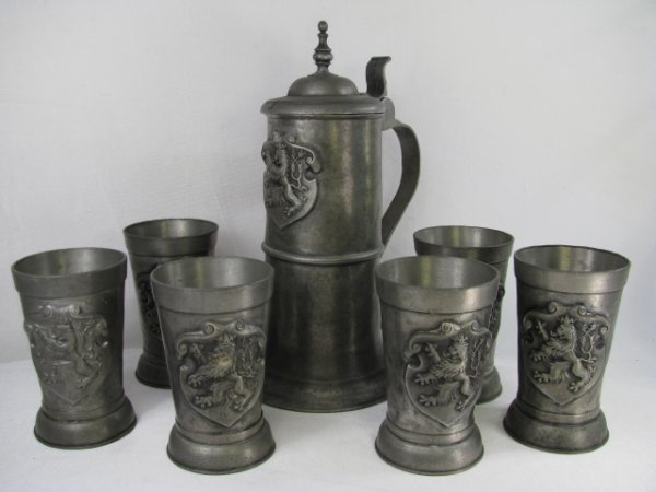 Appraisal: Stein and cups have a lion coat of arms Tankard