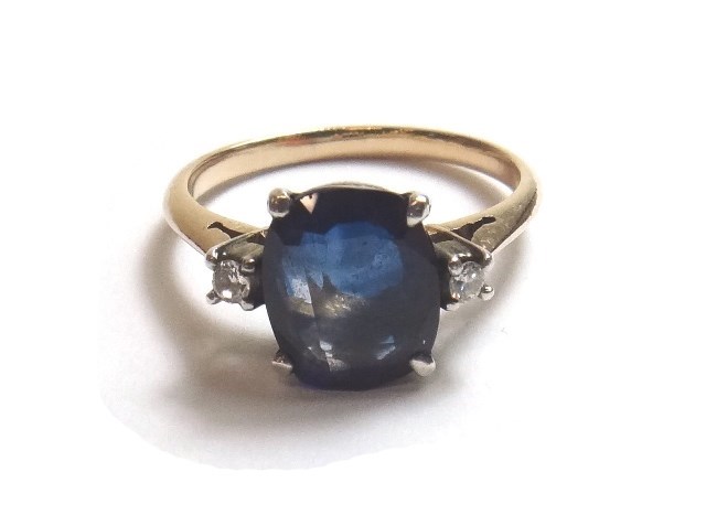 Appraisal: A gold sapphire and diamond set three stone ring claw