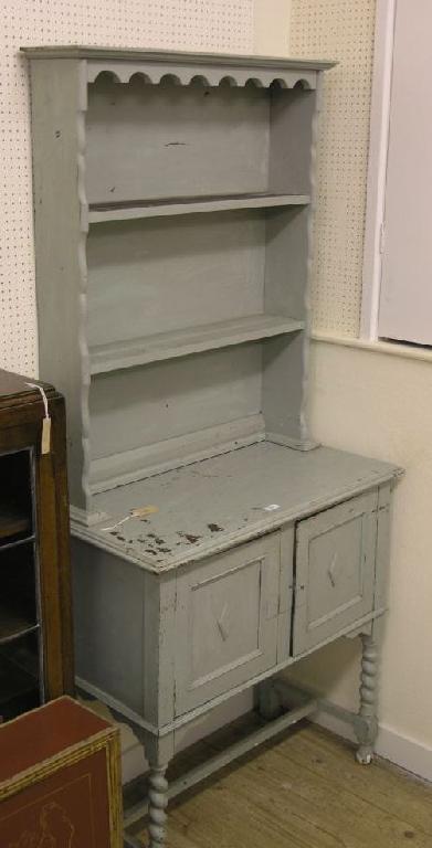 Appraisal: An oak dresser with two shelf plate rack and panelled