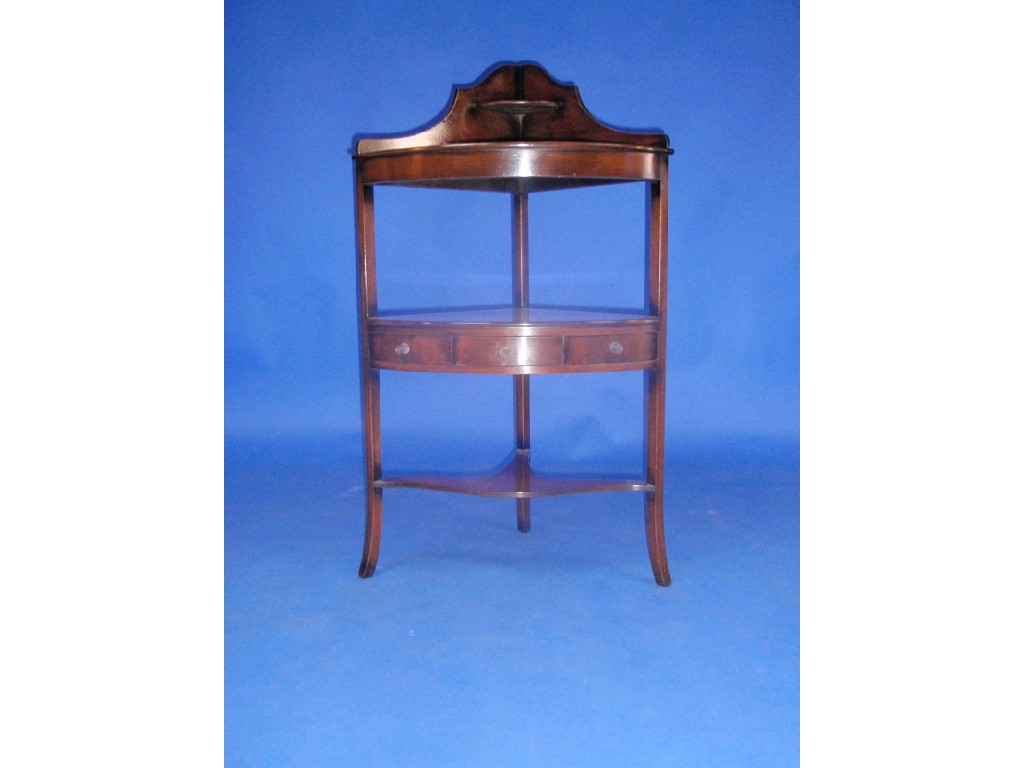 Appraisal: A reproduction flamed mahogany corner washstand