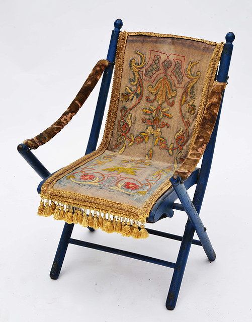 Appraisal: A BLUE PAINTED FOLDING CHILD'S MUSICAL CHAIR with needlework upholstered