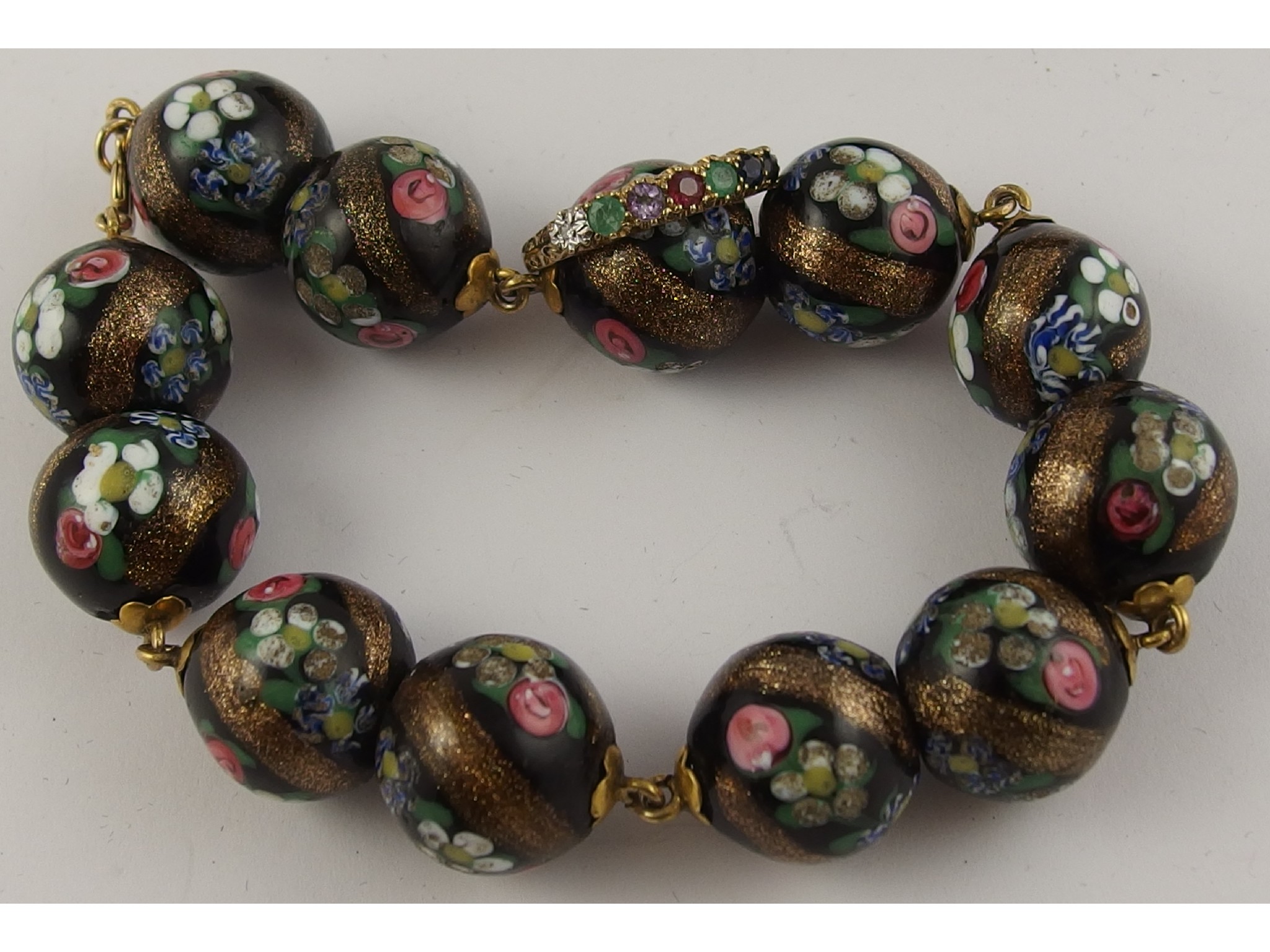 Appraisal: A bracelet of Murano glass beads with yellow metal mounts