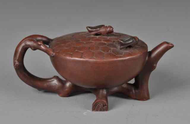 Appraisal: Chinese Yixing Pottery Tea PotFinely molded in the form of