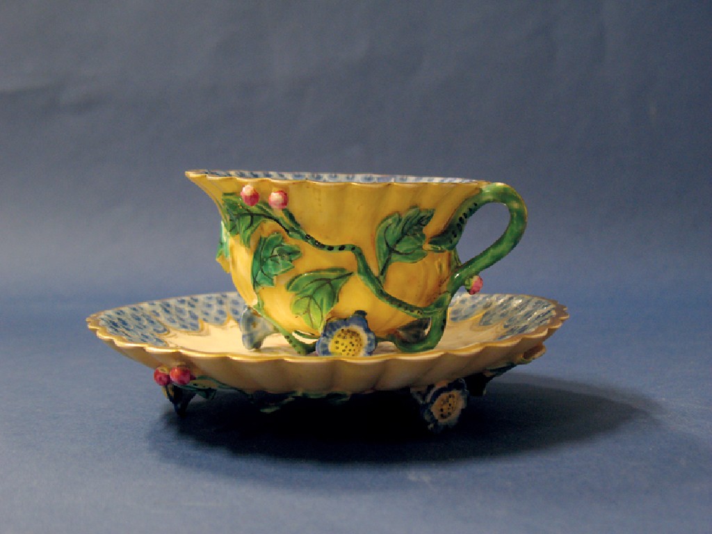 Appraisal: A MINTON CUP AND SAUCER the cup with lobed moulded