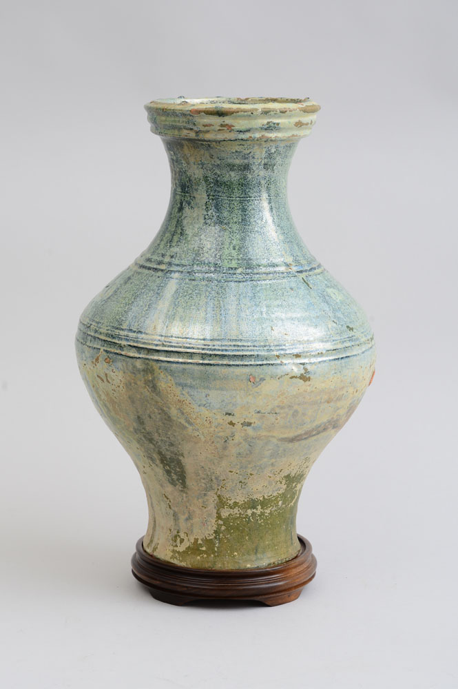 Appraisal: HAN IRIDESCENT GREEN-GLAZED POTTERY VASE The bulbous ringed bowl beneath