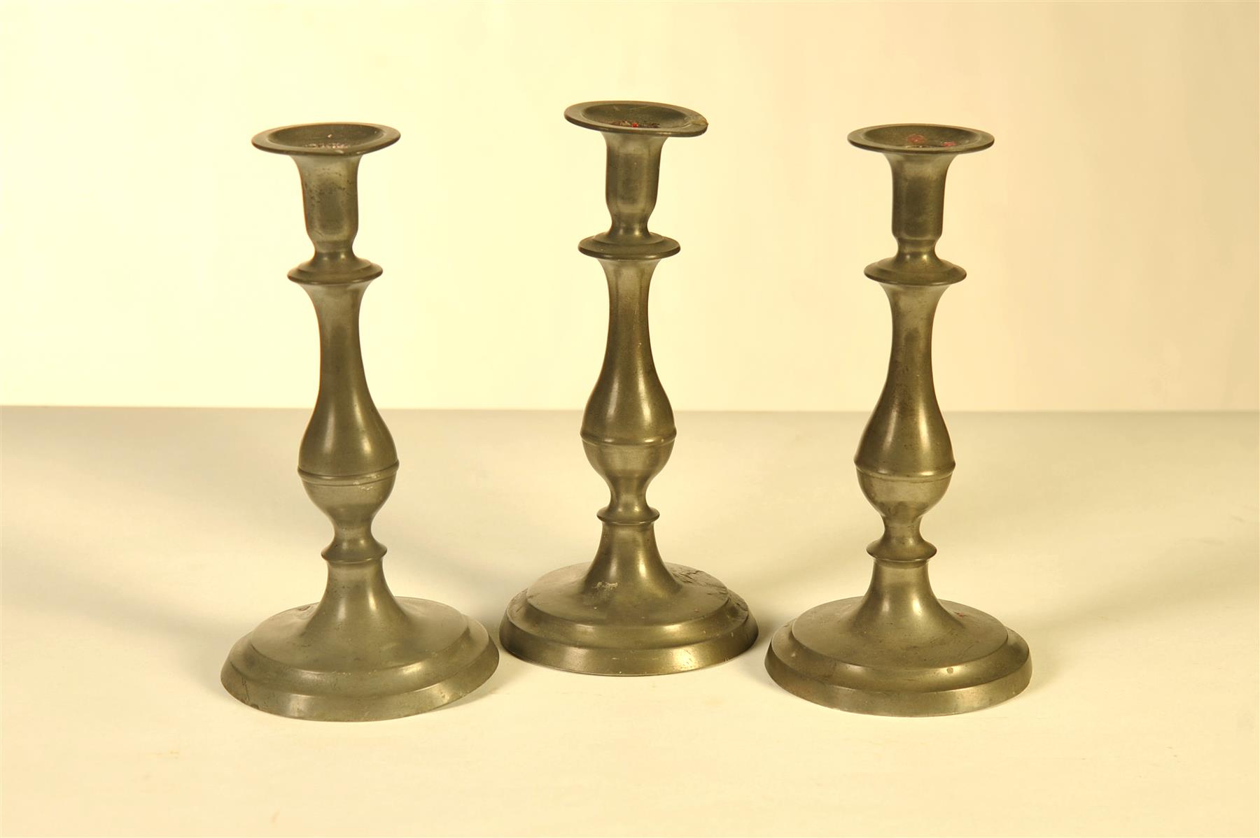 Appraisal: THREE PEWTER CANDLESTICKS Cincinnati Ohio nd quarter- th century Possibly