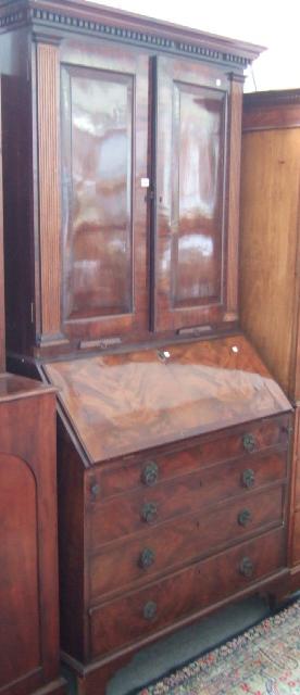 Appraisal: A George III mahogany bureau bookcase the dentil cornice above