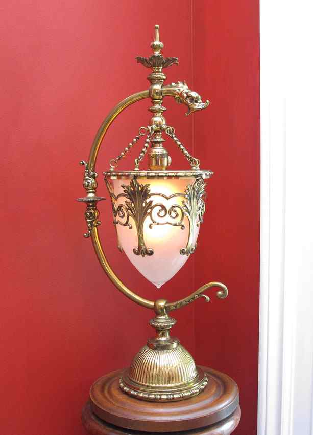 Appraisal: BRASS NEWEL POST LAMP Brass filigree over hanging glass shade