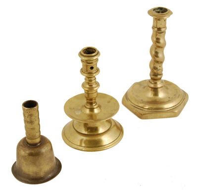 Appraisal: A continental brass candlestick raised on a hexagonal and welled