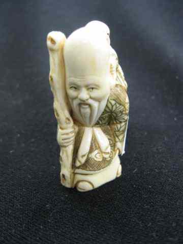 Appraisal: Carved Ivory Netsuke of an Immortal child on back fancy