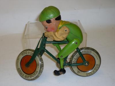 Appraisal: A Triang Gyrocycle Boy on Bicycle tinplate construction celluloid and