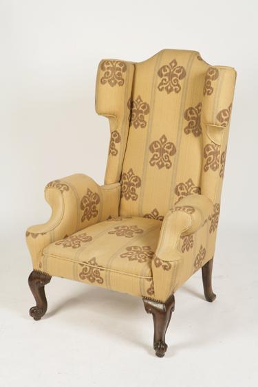 Appraisal: A TH CENTURY FRENCH UPHOLSTERED WING BACK ARMCHAIR the tall