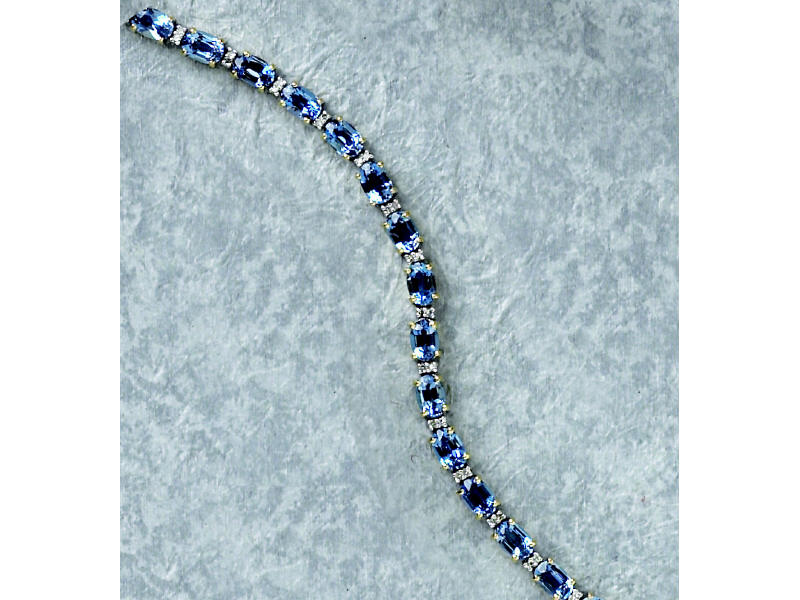 Appraisal: BLUE TOPAZ AND DIAMOND BRACELET k gold bracelet with twenty-three