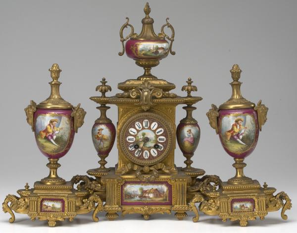 Appraisal: CLOCK GARNITURE French three-piece set in bronze with porcelain dials