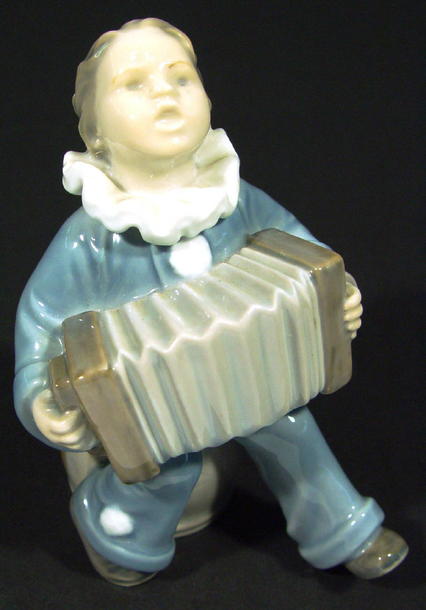 Appraisal: Royal Copenhagen china boy with accordian with hand painted decoration