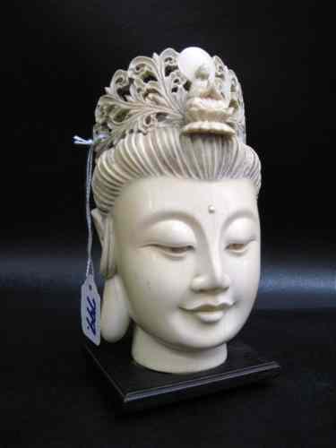 Appraisal: SOLID IVORY HEAD OF GUAN YIN having pierced-carved tiara elongated