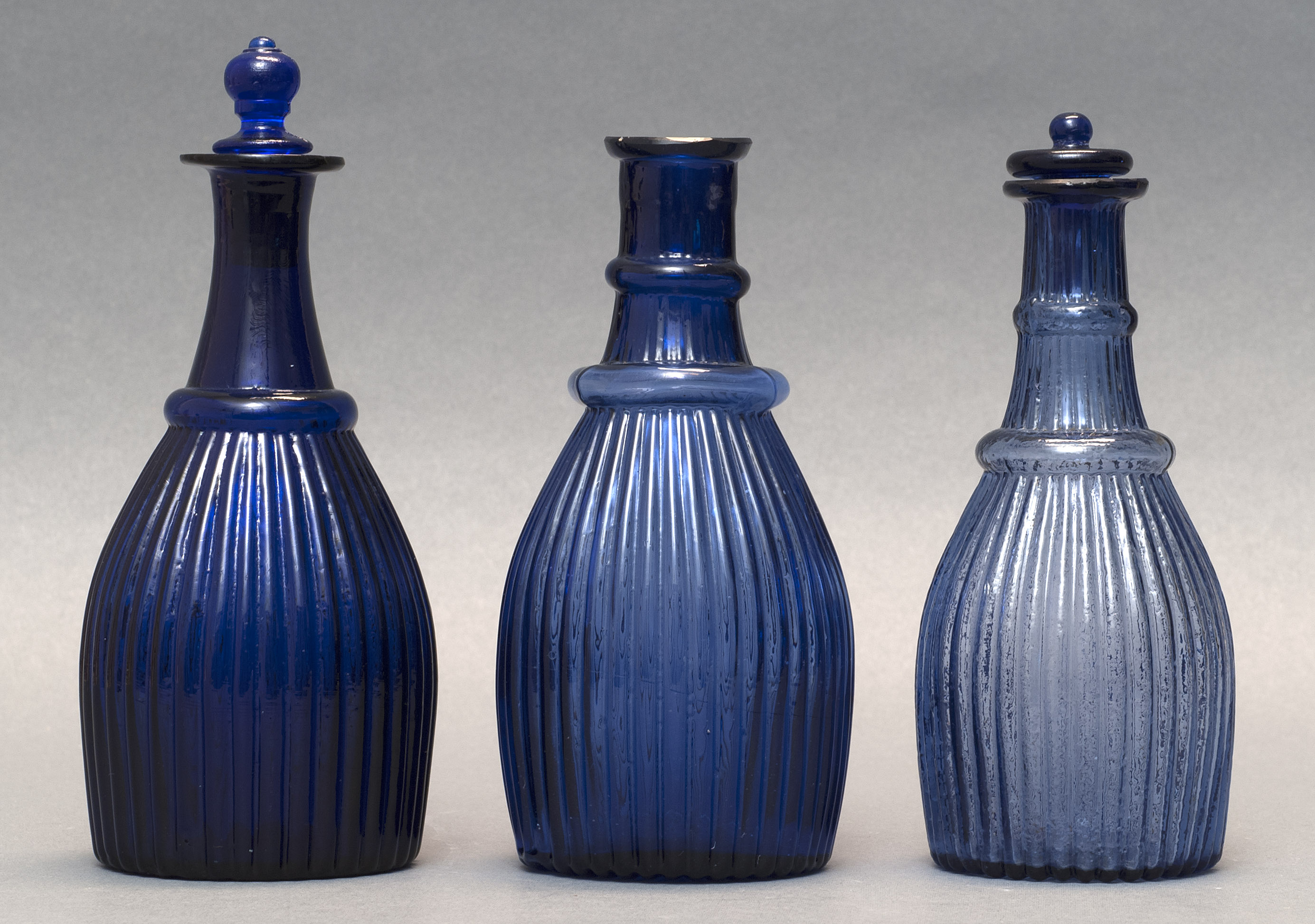 Appraisal: THREE SANDWICH GLASS COMPANY BLOWN-MOLDED GLASS VINEGAR BOTTLES Second Quarter