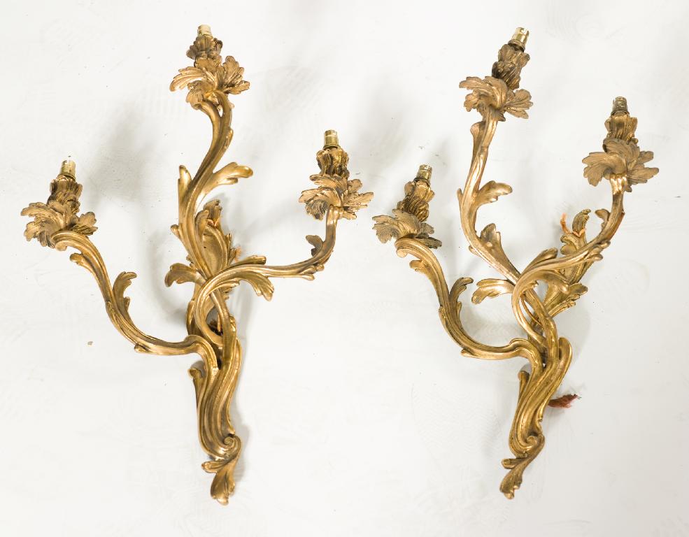 Appraisal: PAIR OF LOUIS XV STYLE GILT-BRONZE THREE-LIGHT WALL APPLIQUES fitted