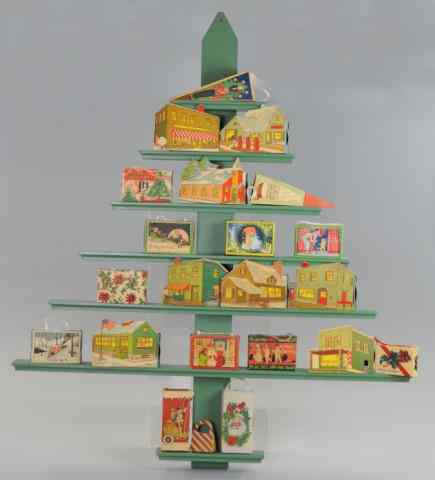 Appraisal: CHRISTMAS CANDY BOXES ON TREE DISPLAY SHELF Novel wood shelving