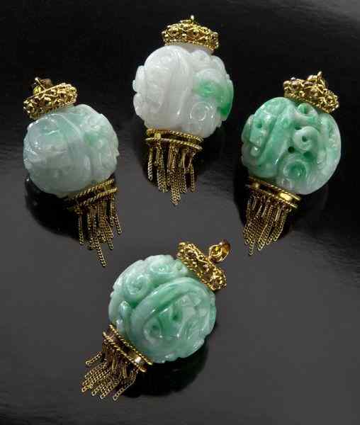 Appraisal: Chinese carved jadeite pendants in K goldmounting All stamped ''