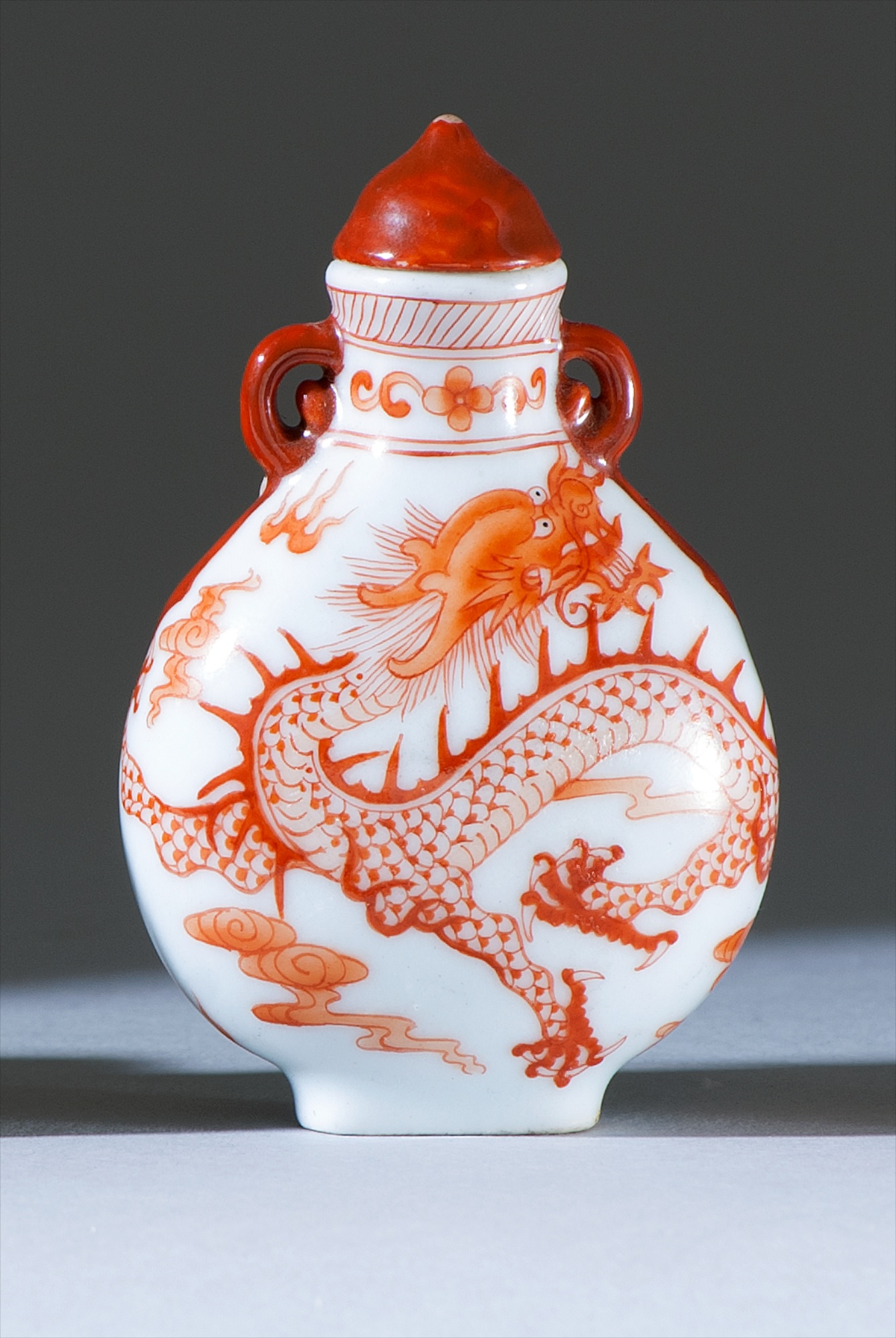 Appraisal: PORCELAIN SNUFF BOTTLE th CenturyIn pear shape with rust-red five-claw