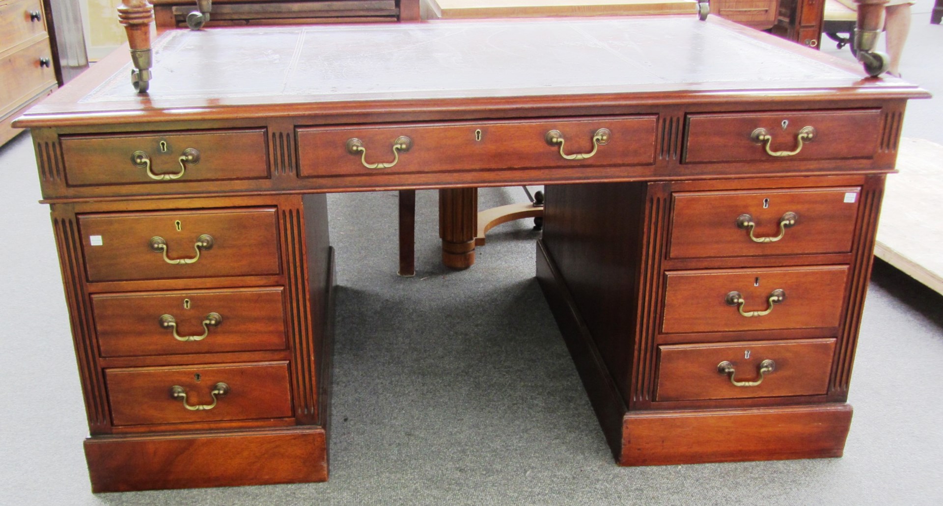 Appraisal: An th century style mahogany pedestal desk with nine drawers