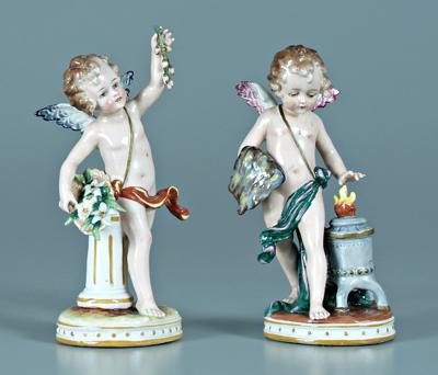 Appraisal: Pair porcelain cupid figurines one warming hands at heater other