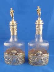 Appraisal: A pair of silver mounted oval decanters with wheel engraved