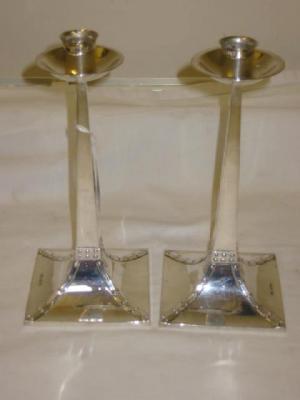 Appraisal: A PAIR OF ARTS AND CRAFTS CANDLESTICKS the sconces on