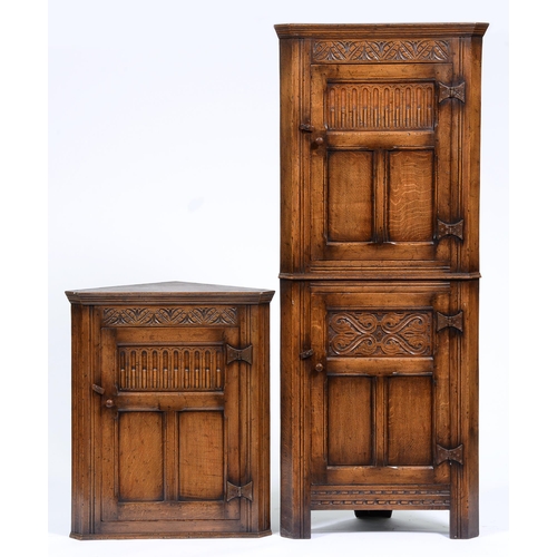 Appraisal: An oak standing corner cupboard with carved panels and iron