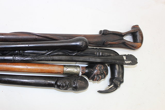 Appraisal: A GROUP OF FIVE EBONY AND HARDWOOD WALKING STICKS and