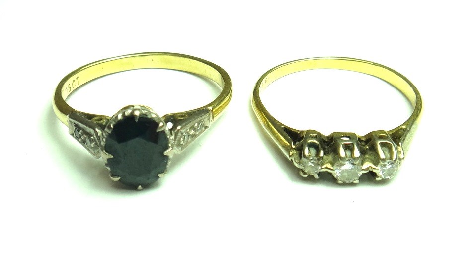 Appraisal: A gold ring claw set with an oval cut sapphire